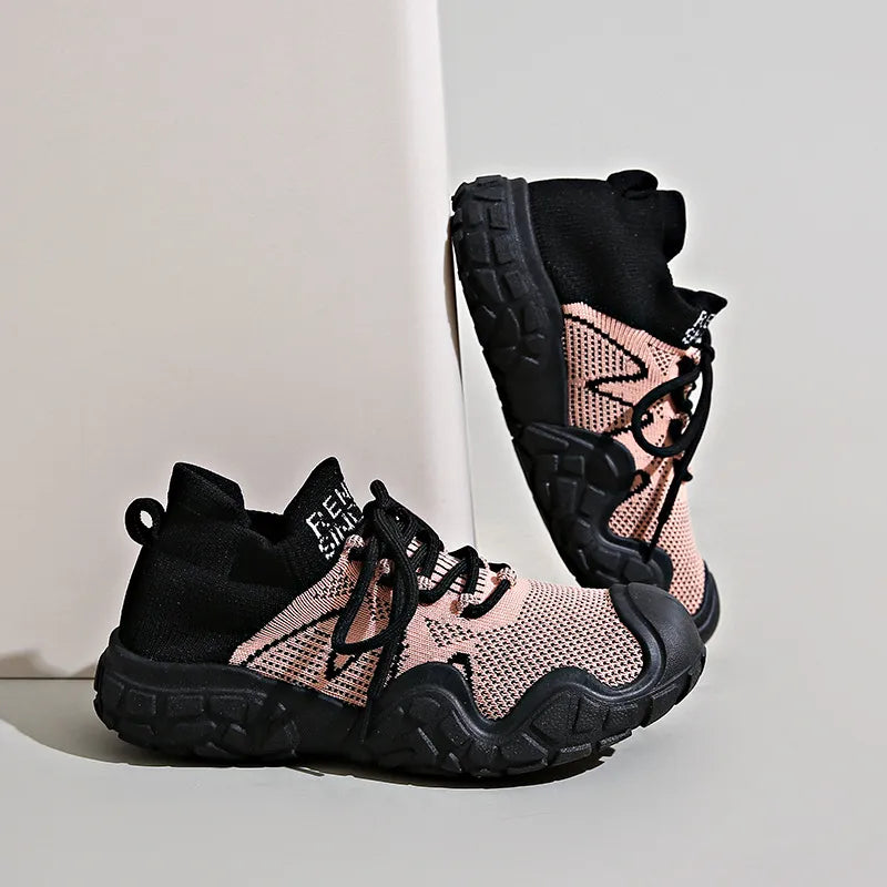 Sculpted knit athleisure sneakers in dusty pink and black with chunky soles.