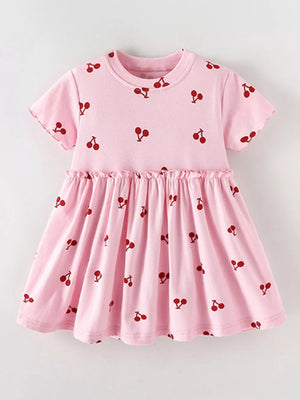 Baby dress in blush pink with a red cherry print, short sleeves, and ruffled waist.