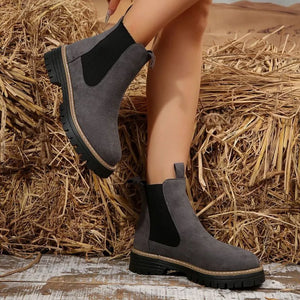 Gray suede platform ankle boots with black elastic side panels and chunky lug sole