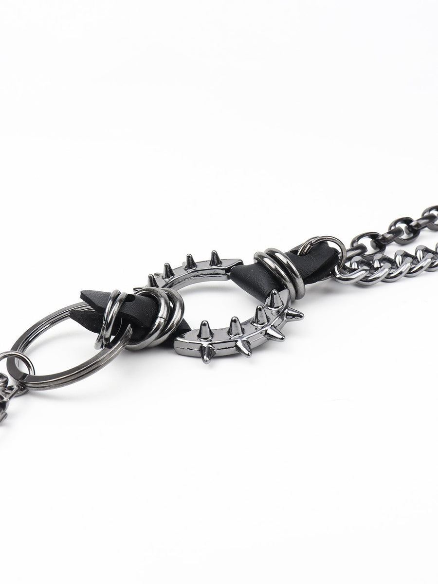 Black spiked chain harness belt with metal ring detail and aluminum spikes.