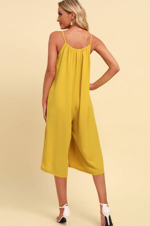 Yellow culotte jumpsuit with gathered bodice and spaghetti straps.