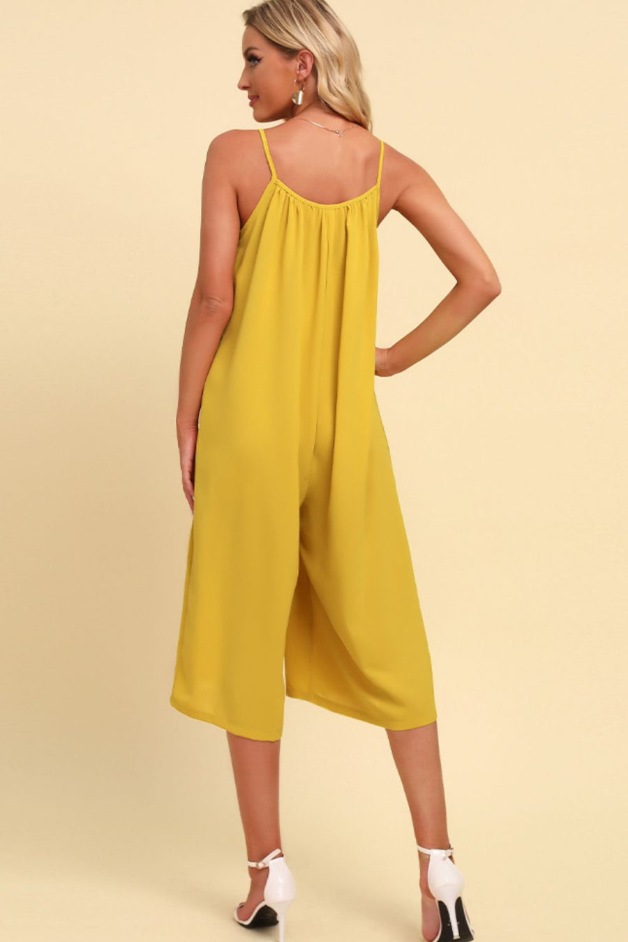 Yellow culotte jumpsuit with gathered bodice and spaghetti straps.