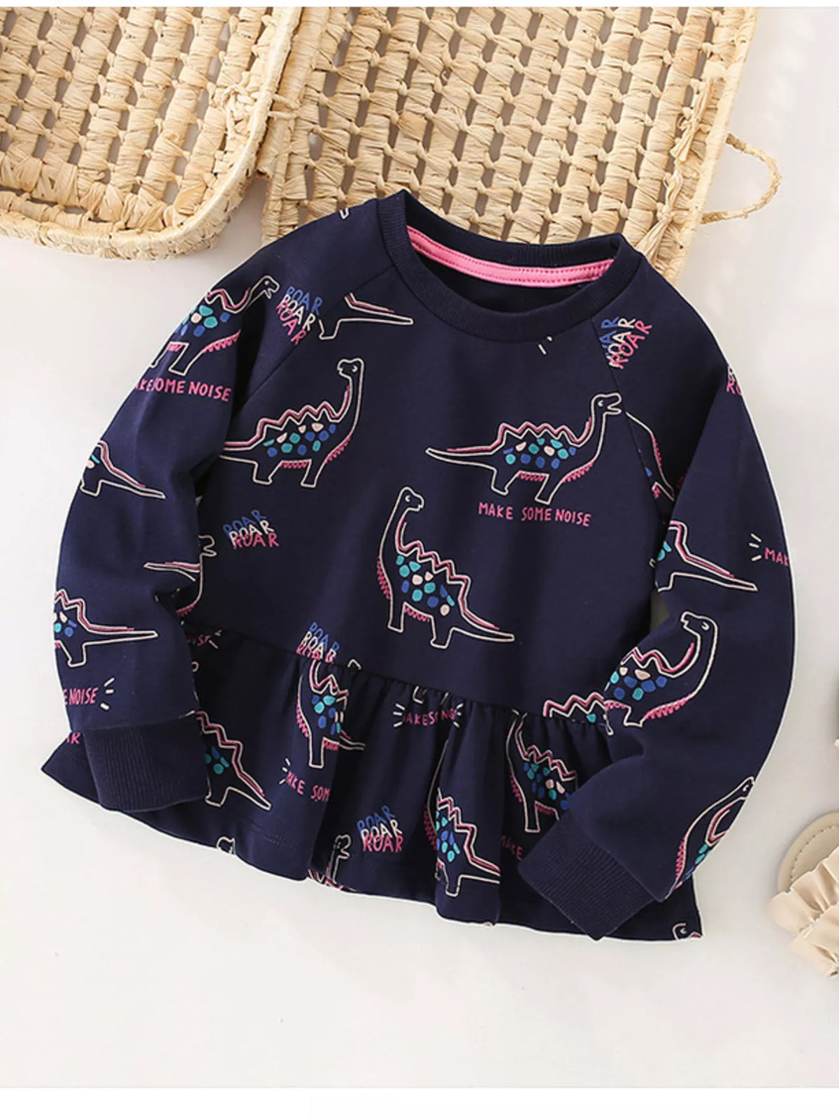 Dark navy cotton sweatshirt with dinosaur print and ruffled hem.