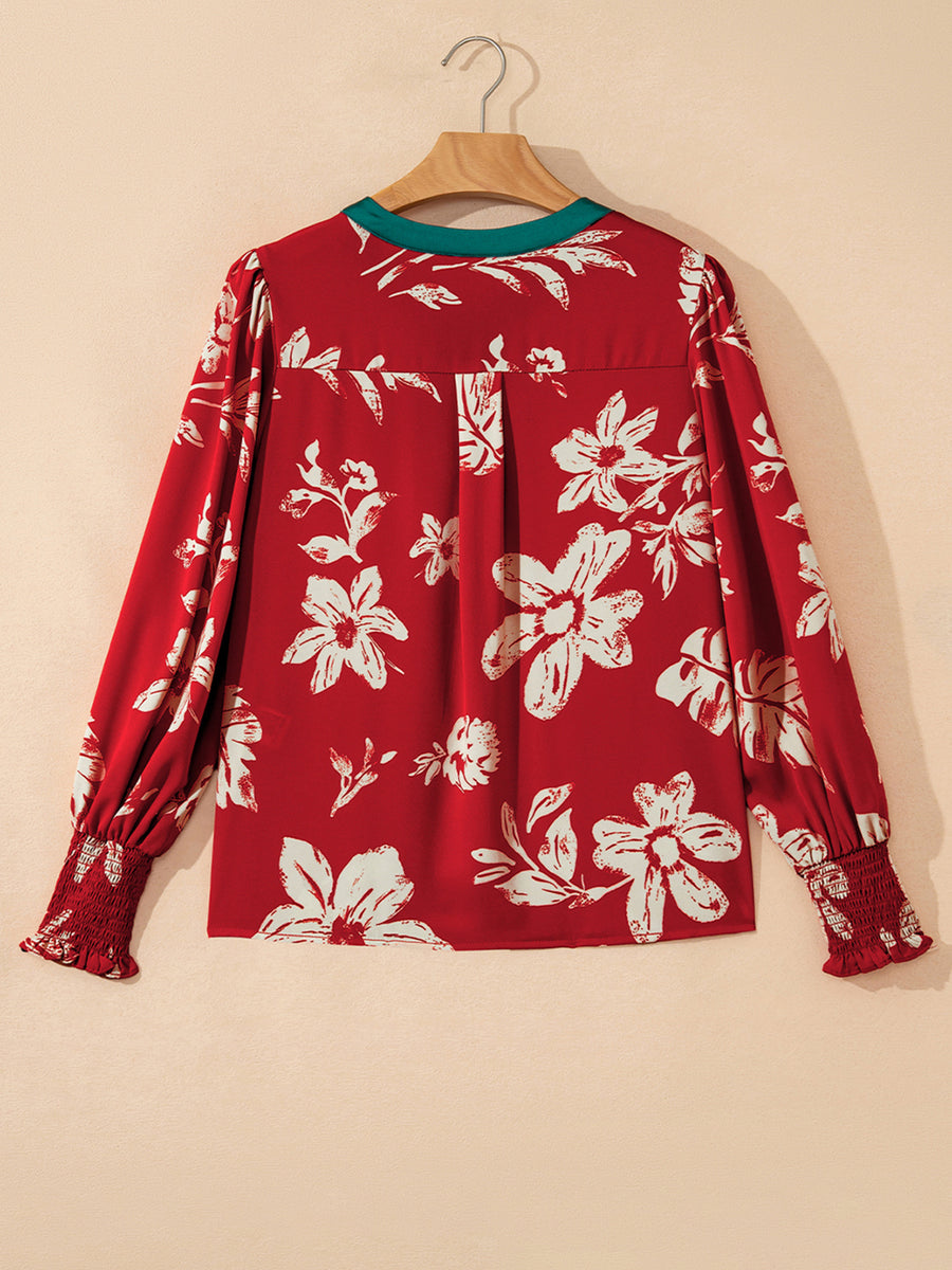 Red floral print blouse with green trim and smocked cuffs