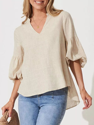 Maternity shirt with notched V-neck, balloon sleeves, and asymmetrical hem in natural linen-look fabric.