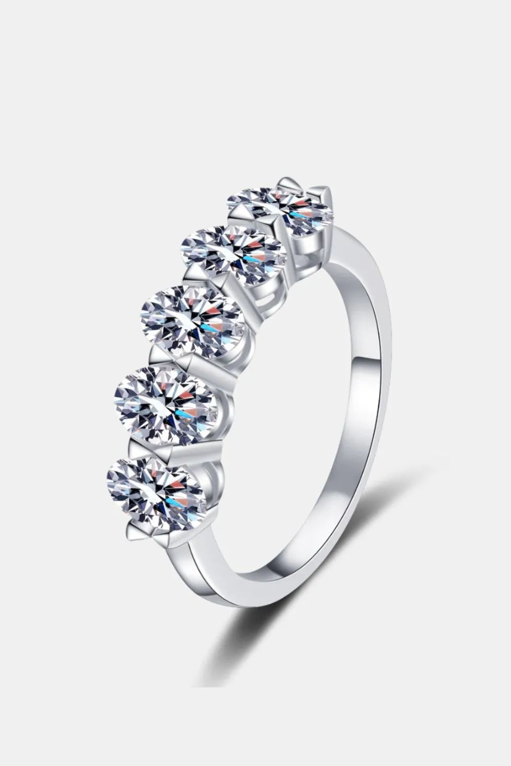 Silver moissanite band ring with five round-cut stones