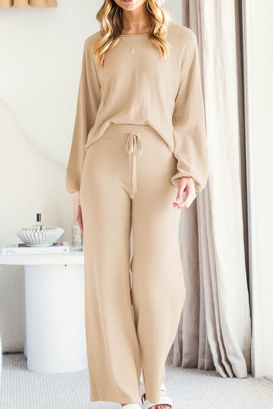 Beige knit sweater with long sleeves and wide leg pants with drawstring waist