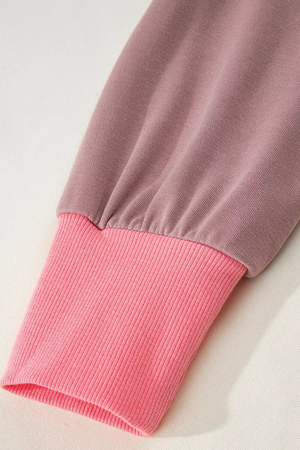 sweatshirt in hot pink with exposed seam and hip-length