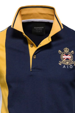 Colorblock polo shirt in navy and yellow with embroidered crest detail.