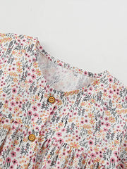 Toddler cotton dress with floral print, button front, and ruffle sleeves.