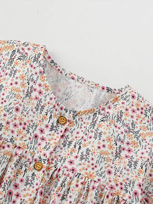 Toddler cotton dress with floral print, button front, and ruffle sleeves.