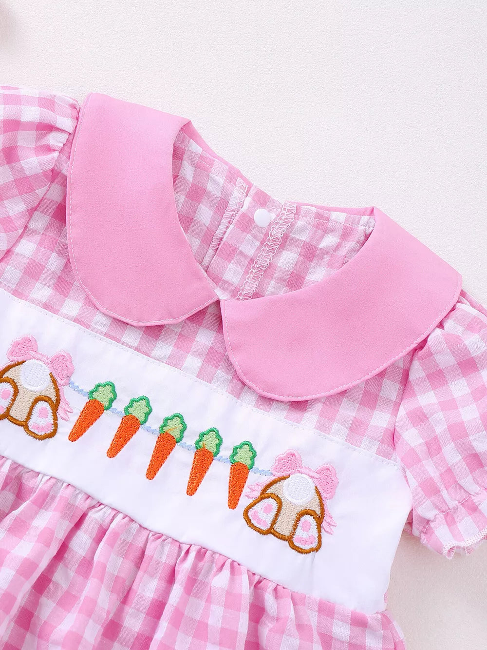 Pink gingham baby dress with bunny and carrot embroidery and a Peter Pan collar.