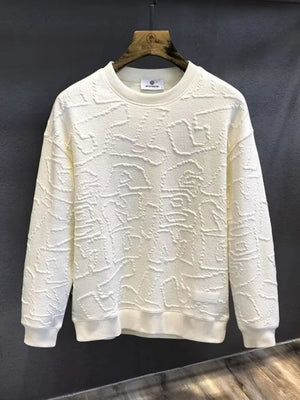 Ivory crewneck sweatshirt with allover embossed geometric texture and ribbed cuffs and hem.