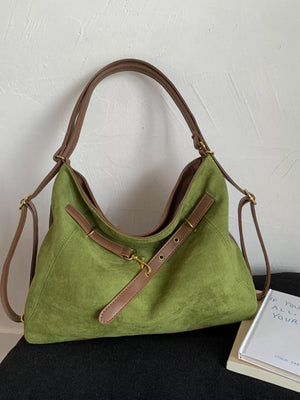 Sage green hobo bag with adjustable brown strap and gold hardware, suede-like texture