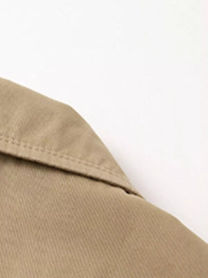 Khaki cotton lapel blazer detail with visible stitching.