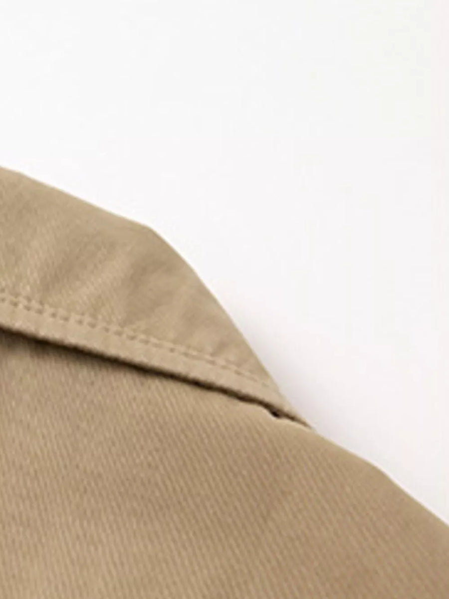 Khaki cotton lapel blazer detail with visible stitching.