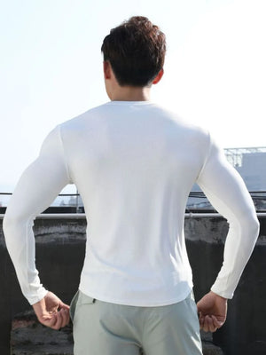 White ribbed long sleeve t-shirt with a V-neck and a sculpted fit.