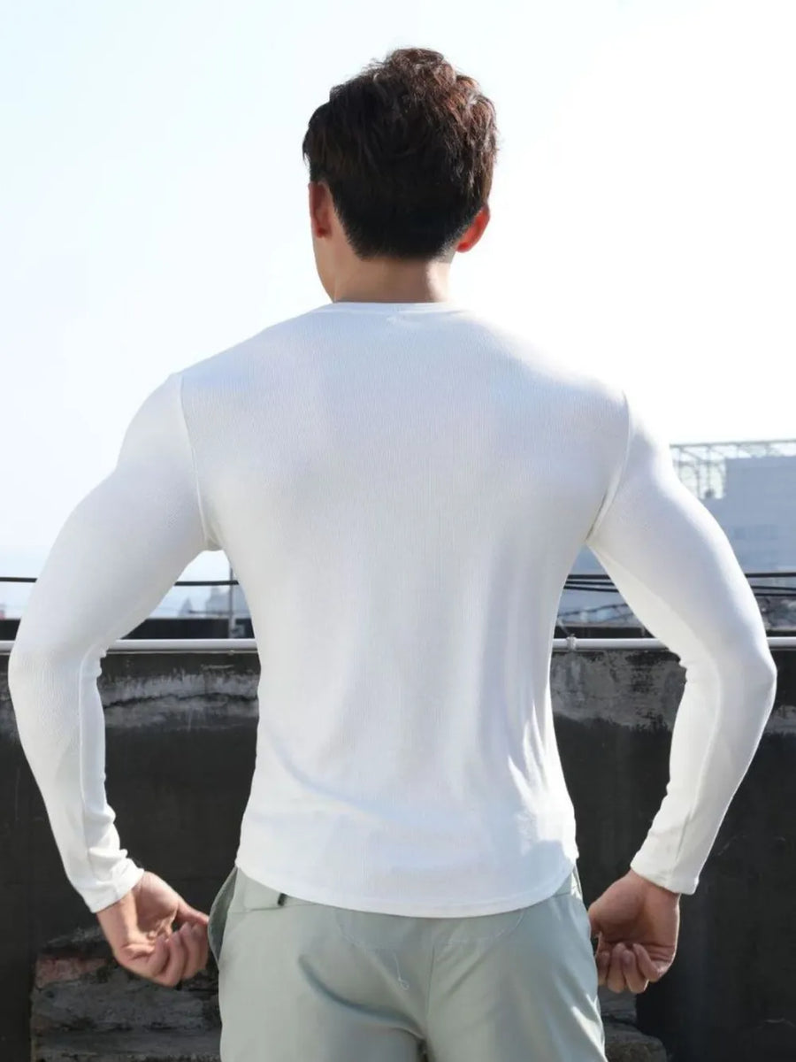 White ribbed long sleeve t-shirt with a V-neck and a sculpted fit.