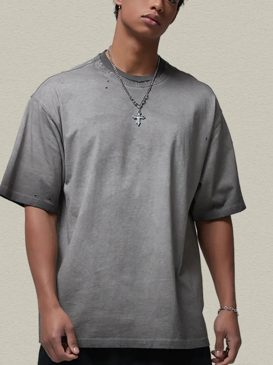 Gray oversized cotton tee with distressed details and washed effect.