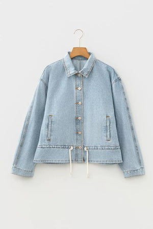 Light wash cotton denim jacket with button-down front and adjustable draw-cord hem