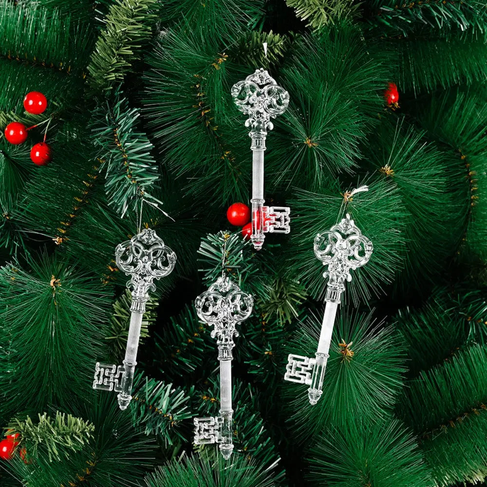 Clear crystal key Christmas ornaments hang on a green artificial tree with red berries.