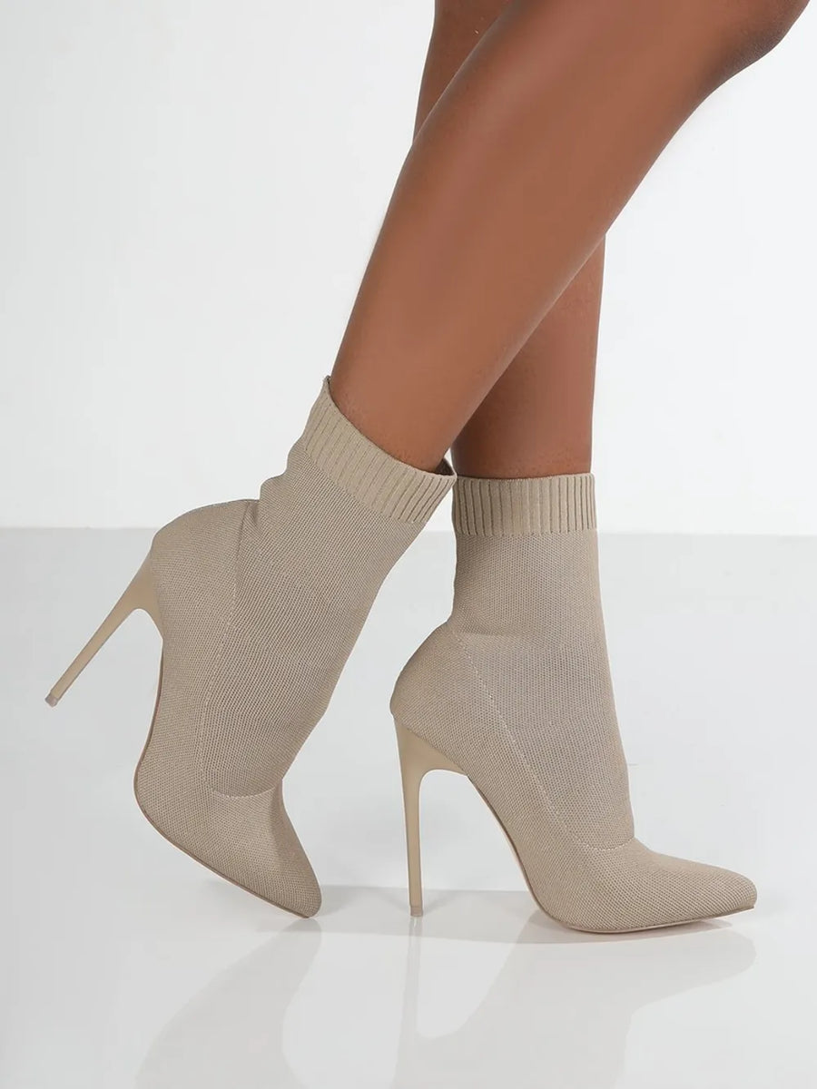 Beige knit sock booties with pointed toe and stiletto heel.