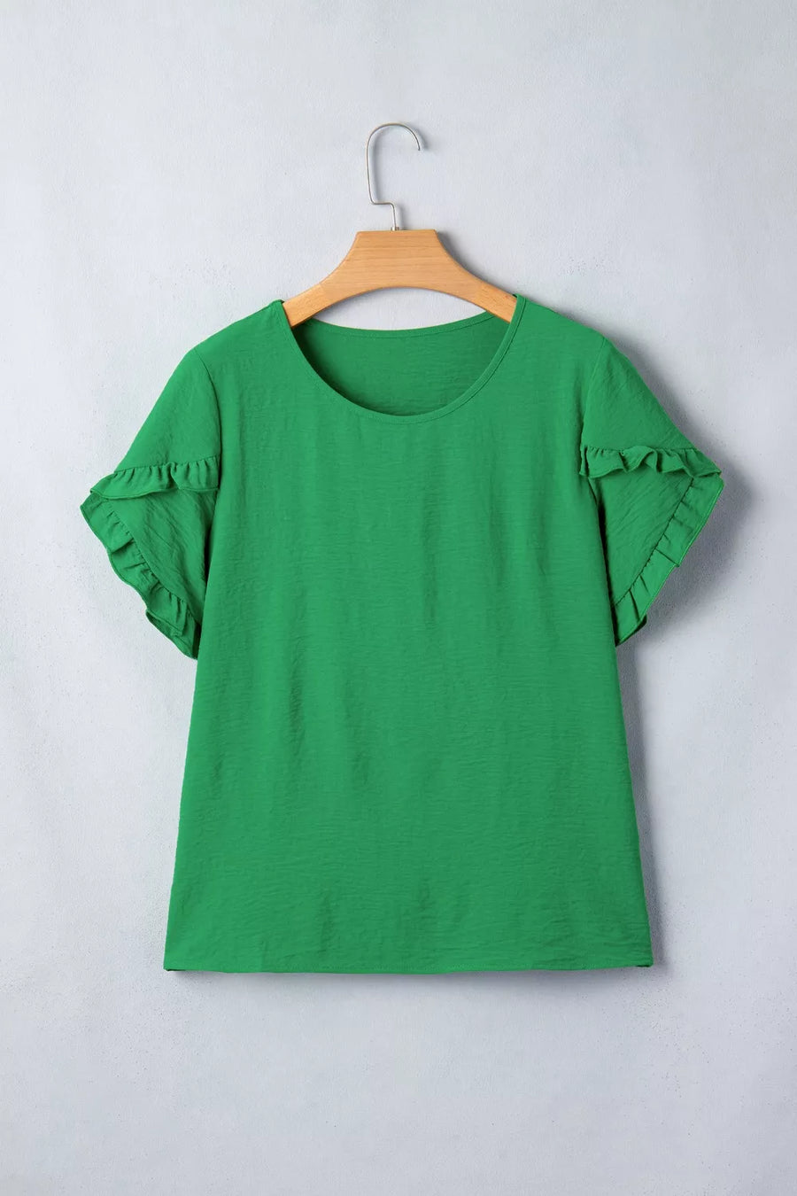 Green polyester blouse with short ruffled sleeves and a crew neck.