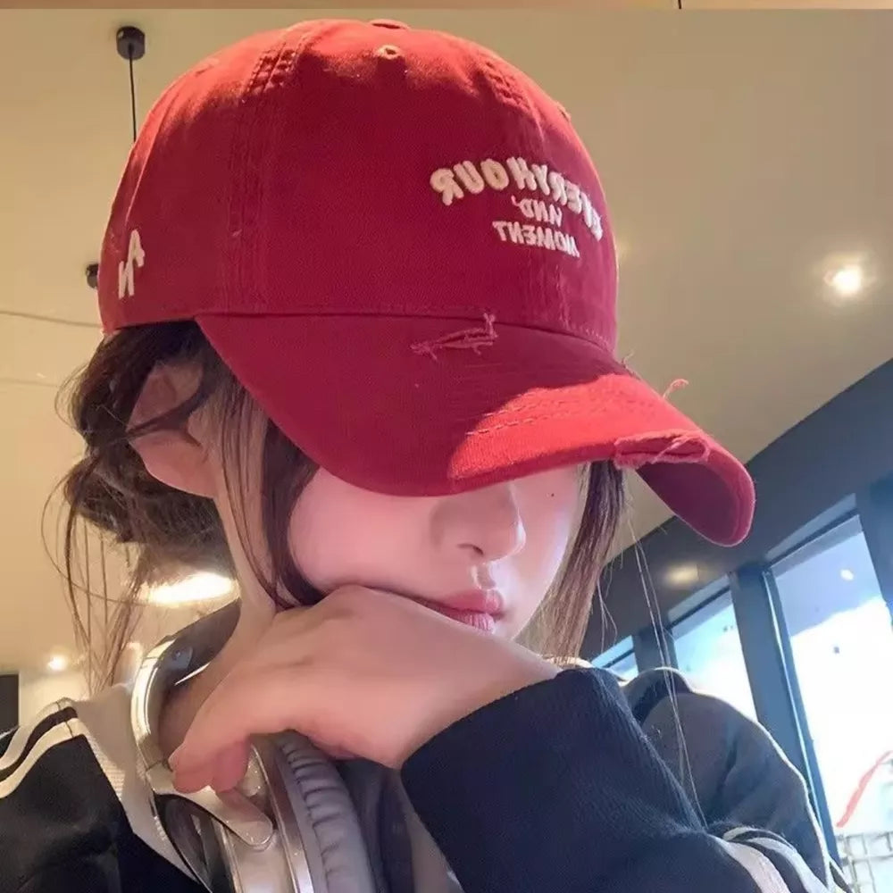 Burgundy distressed baseball cap with white embroidery and frayed brim.