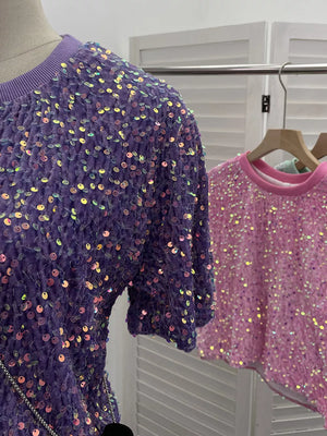 Purple crew neck t-shirt with iridescent sequin embellishments and textured fabric.