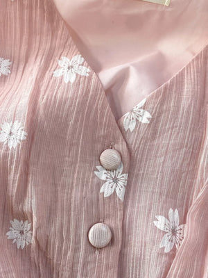 Dusty pink midi dress with white floral embroidery and button details.