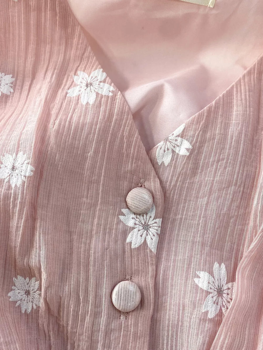 Dusty pink midi dress with white floral embroidery and button details.