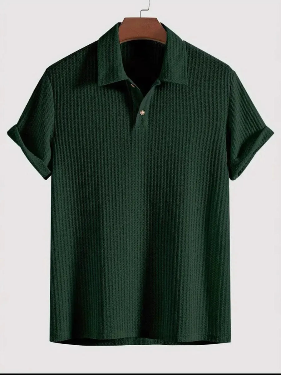 Dark green textured polo shirt with rolled sleeves and a buttoned collar.