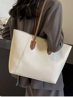 Chic white structured PU leather tote bag with brown straps and clean silhouette.