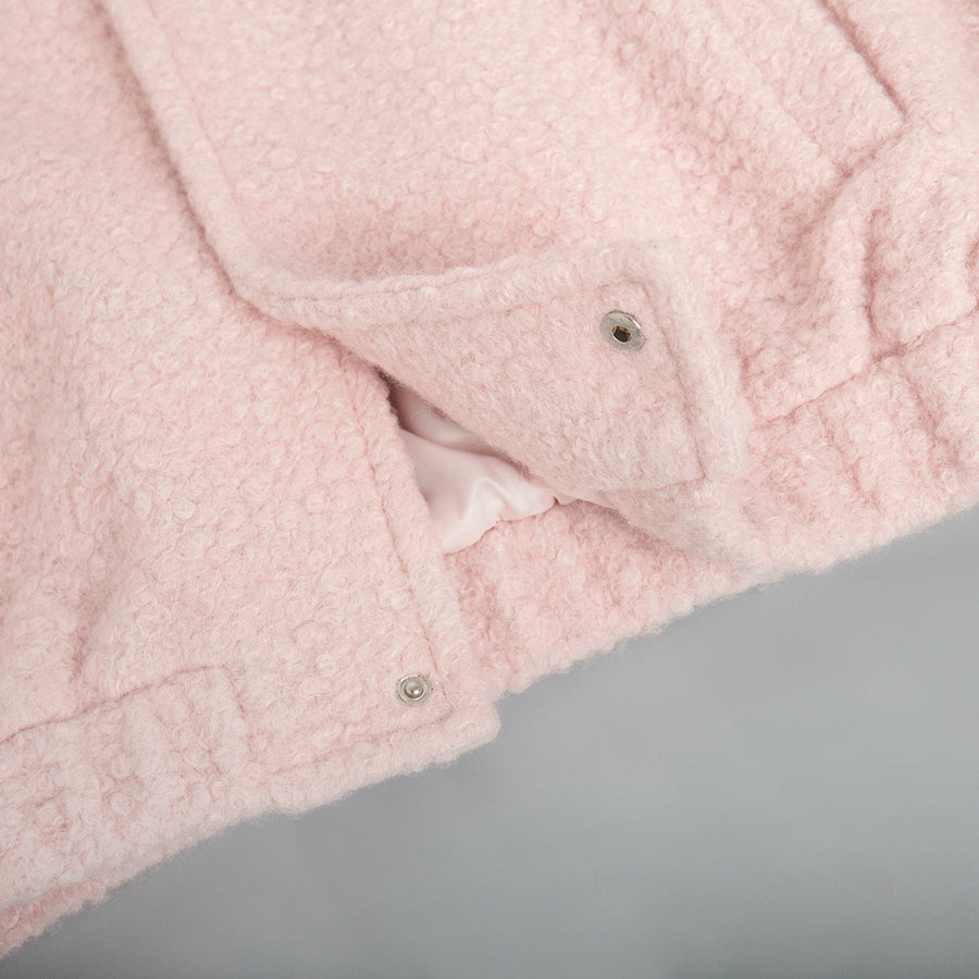 Textured blush pink bouclé bomber jacket with snap closure detail