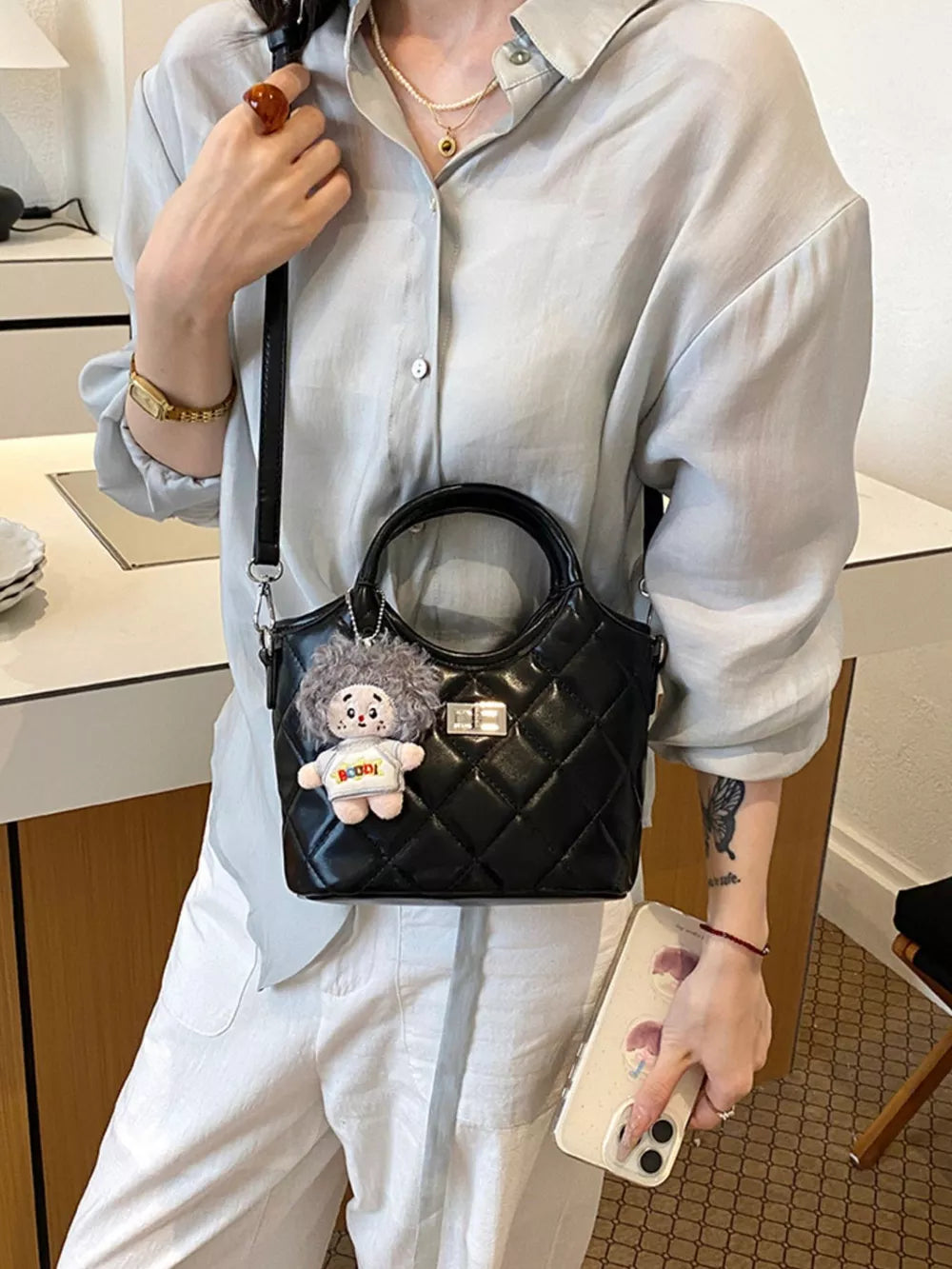 Quilted Crossbody Bag With Plush Charm in black with quilted