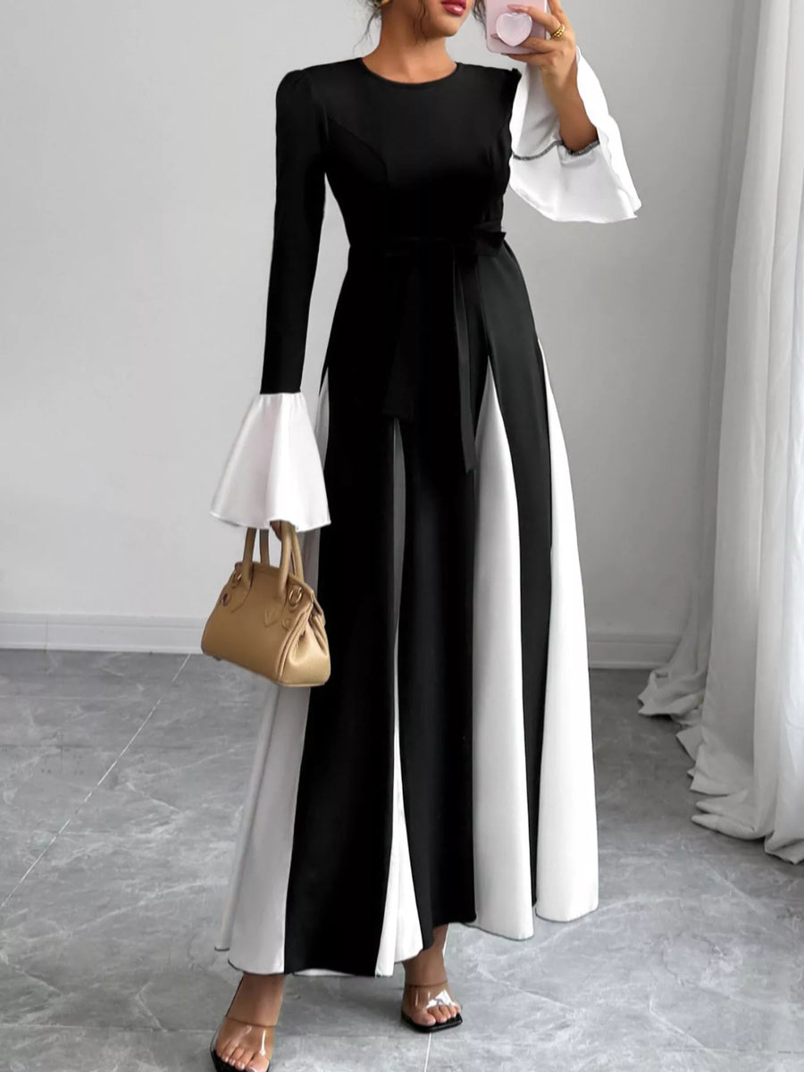 Black maxi dress with tie waist and white flare sleeves.
