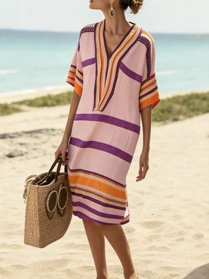 Striped midi dress with V-neck and half sleeves in pink with purple and orange stripes.