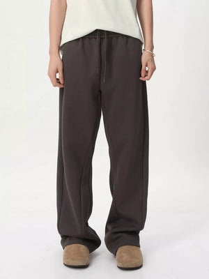 Relaxed fit sweatpants in dark gray with adjustable drawstring waist and side seams.