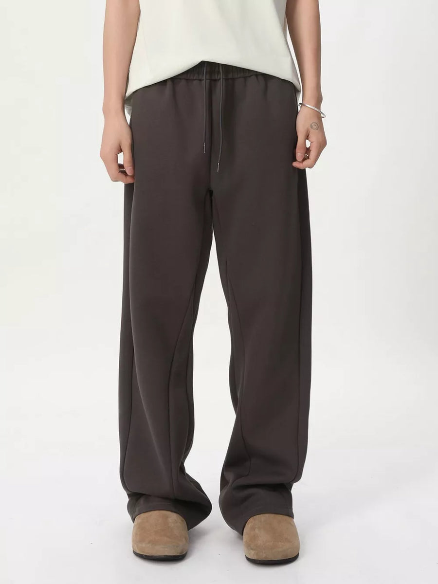 Relaxed fit sweatpants in dark gray with adjustable drawstring waist and side seams.