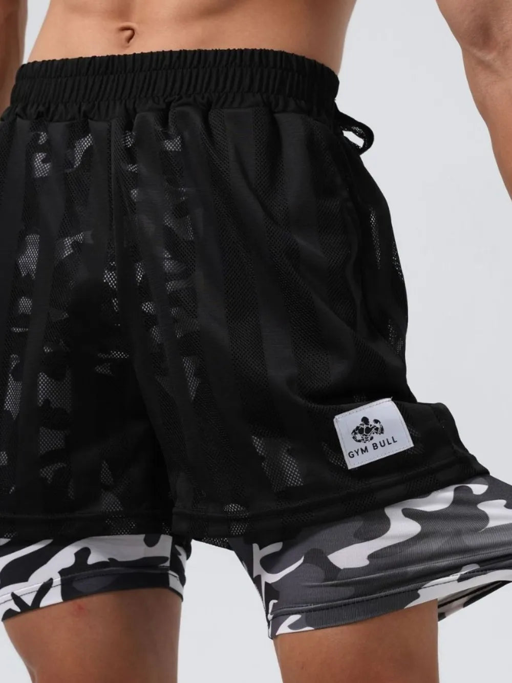 Black layered mesh performance shorts with camo print inner shorts and Gym Bull logo tag.