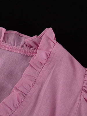 Pink linen blend top with ruffled neckline and short sleeves.