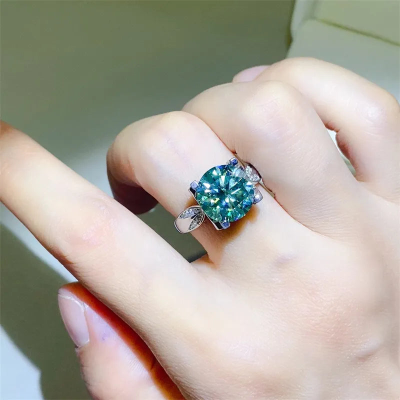 Silver ring with a large green moissanite solitaire and sculpted band.