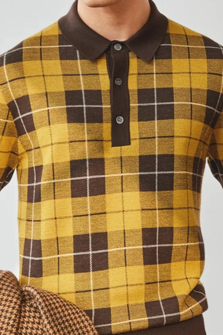 Checked knit polo with contrast trim in plaid, featuring a buttoned neckline and acrylic material.