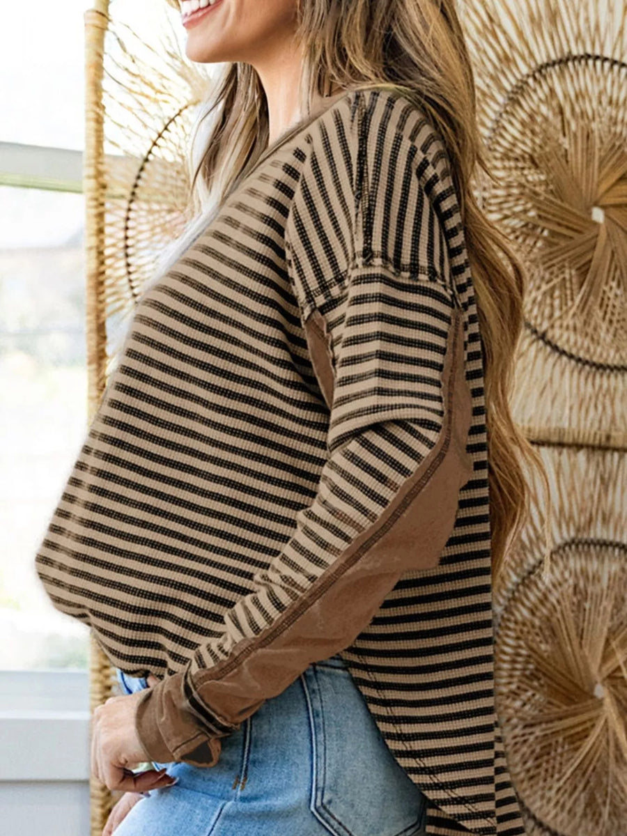 Casual drop shoulder knit top in taupe with black stripes and contrast elbow patches.