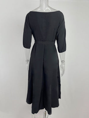 Black belted midi dress with 3/4 sleeves and a-line skirt.