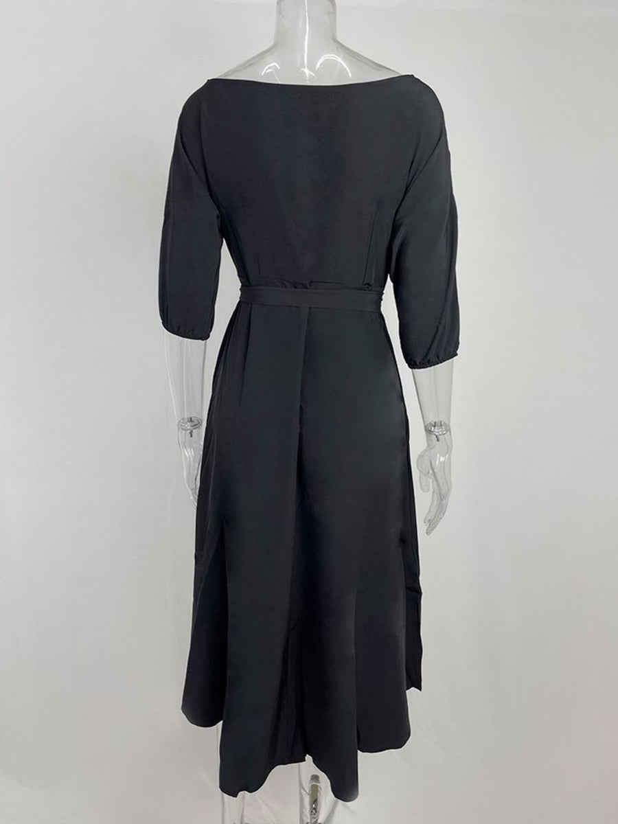 Black belted midi dress with 3/4 sleeves and a-line skirt.
