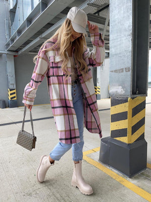 Long plaid shirt jacket in pink, white, and black with collar and button front, worn open over a tan top.