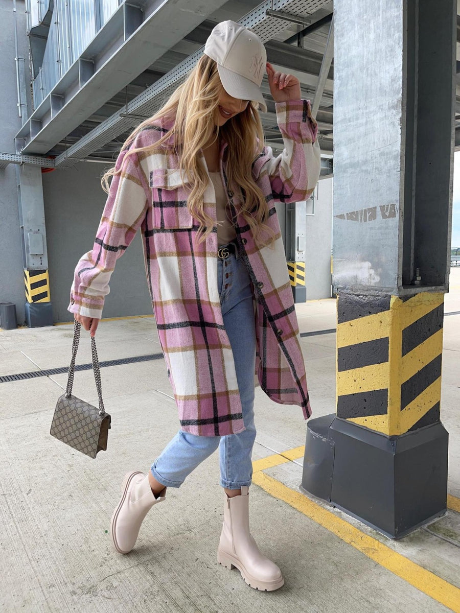 Long plaid shirt jacket in pink, white, and black with collar and button front, worn open over a tan top.