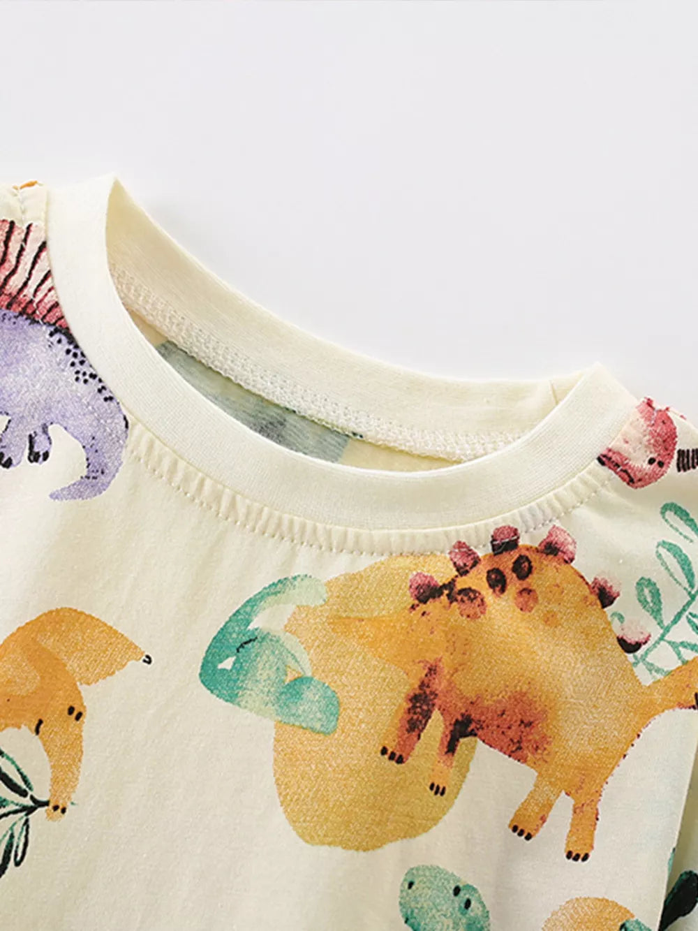 Baby t-shirt in cream cotton blend with colorful dinosaur print and crew neck.