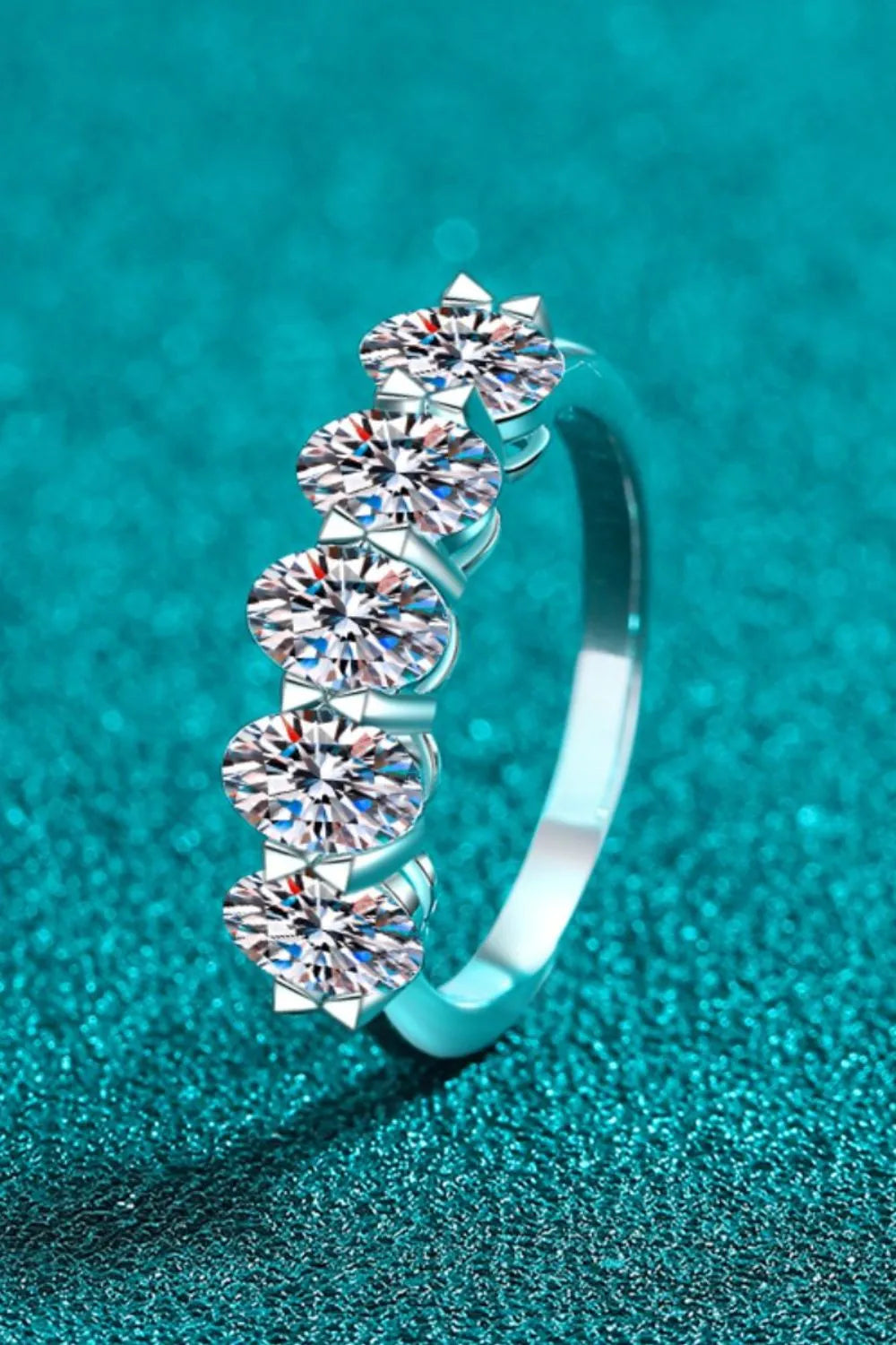Silver moissanite band ring with five round-cut stones set in a cluster.